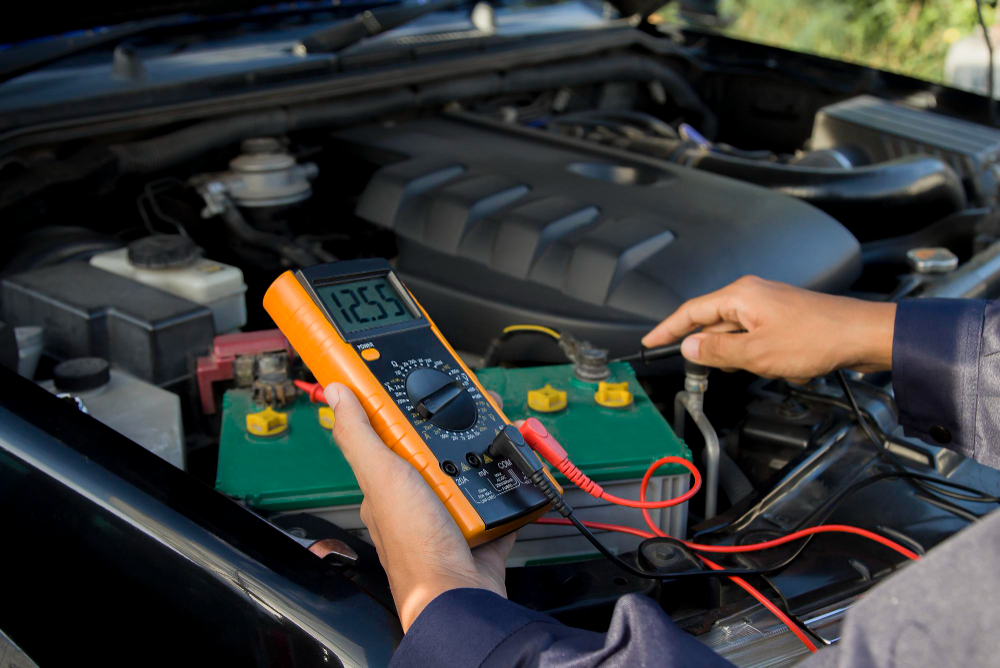 A hybrid car specialist servicing a Toyota car battery with a voltage multimeter.