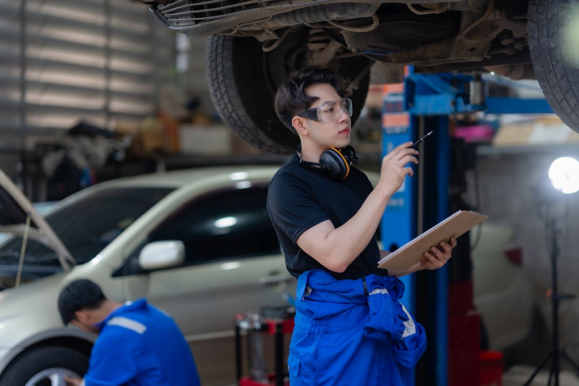 A hybrid car specialist is working on a Toyota hybrid car in a Singapore Car Workshop.